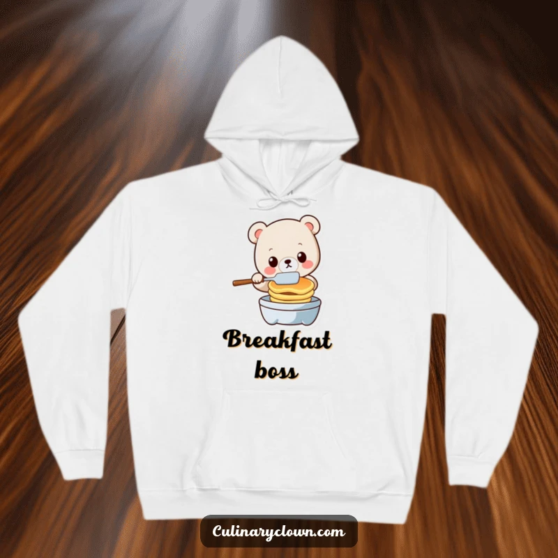 Funny kawaii bear character in a humorous pancake flipping pose, wearing a cozy hoodie, expressing kitchen mishaps.