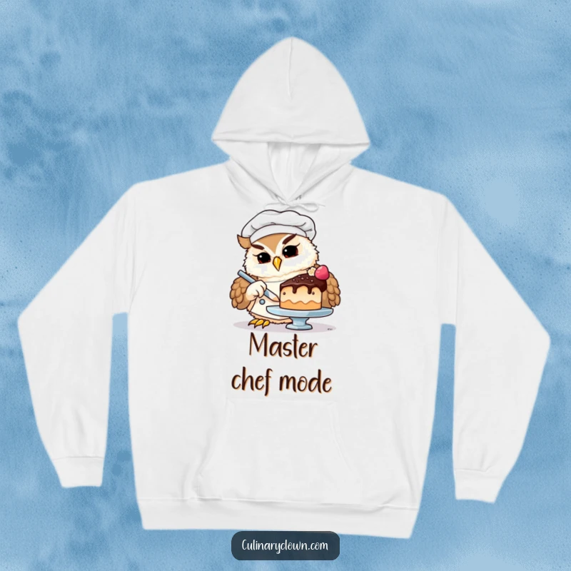 Funny owl chef hoodie design showing a focused owl in a chef uniform, expertly placing a tiny cherry on a miniature cake.
