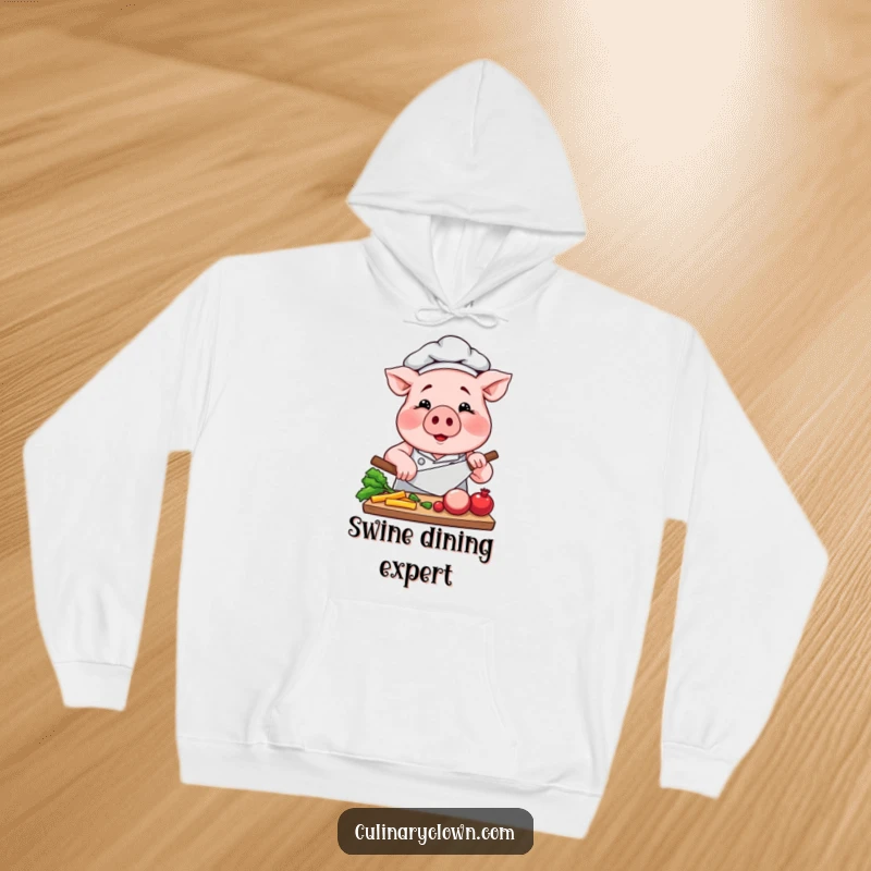 Funny Pig Chef Hoodie: A focused pig in chef attire skillfully chops vegetables, offering warmth and kitchen inspiration.