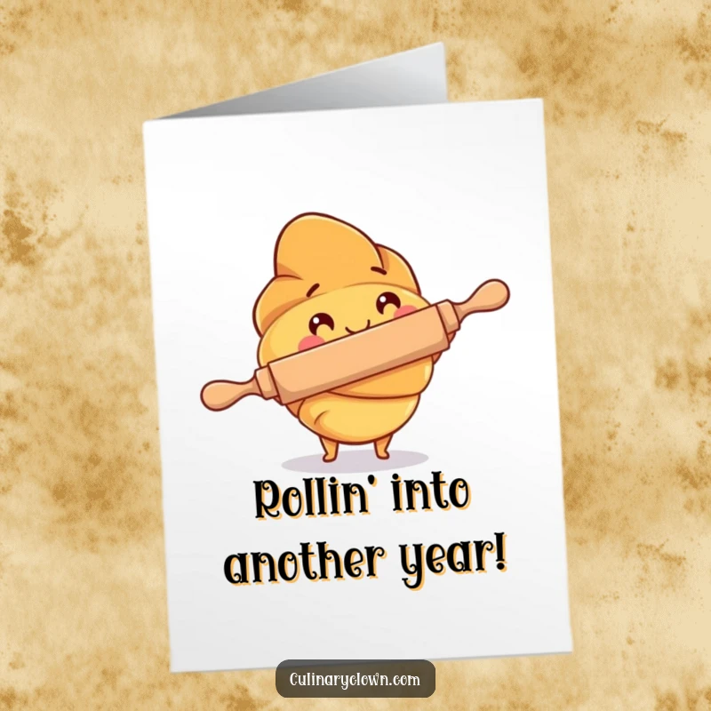 Funny free printable birthday card showing a happy croissant character energetically using a rolling pin, preparing dough for a birthday.